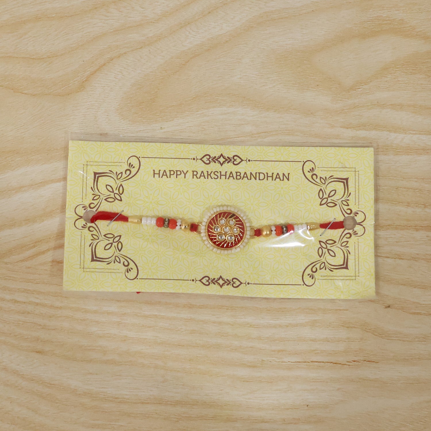 Festive rakhi with golden floral centerpiece and beads
