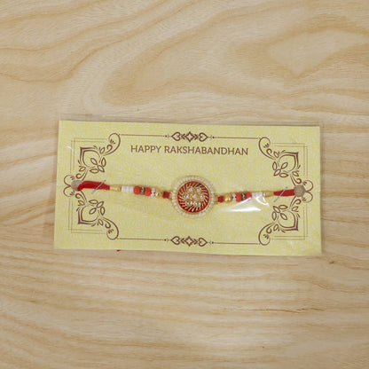 Festive rakhi with golden floral centerpiece and beads