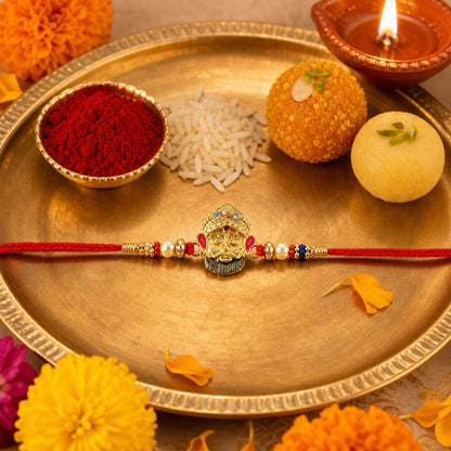 Side view of traditional designer rakhi with red thread