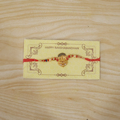 Fully spread traditional rakhi with decorative beads and red thread