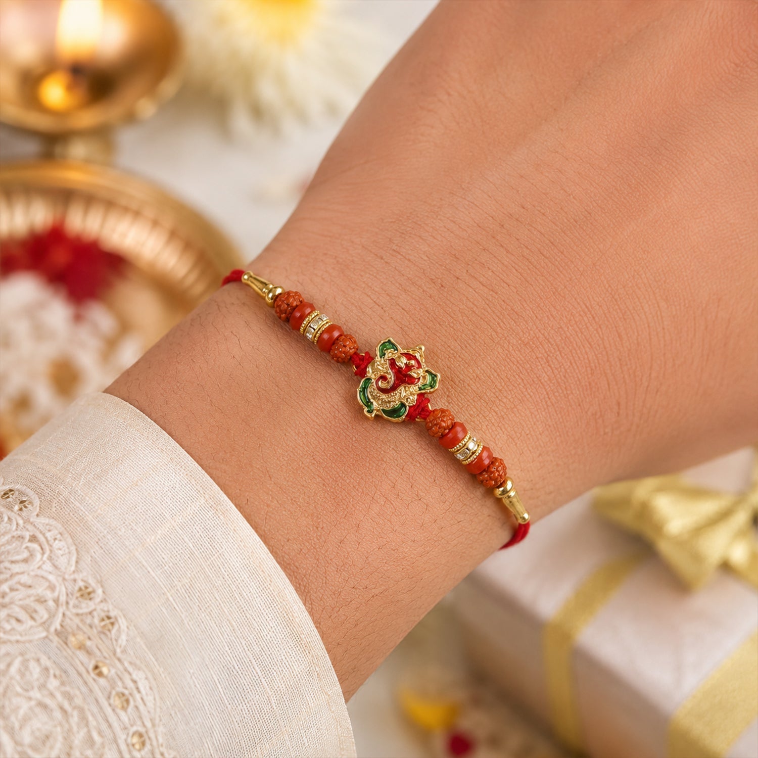 Close-up of Ganesh motif and Rudraksha beads on designer rakhi