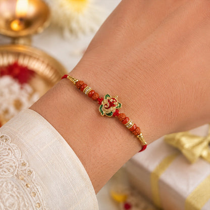 Close-up of Ganesh motif and Rudraksha beads on designer rakhi