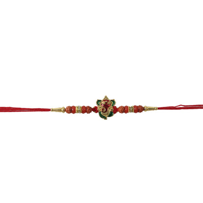 Ganesh Designer Rakhi arranged on plain surface