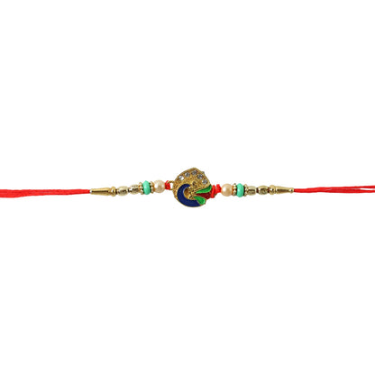 Peacock rakhi with pearl beads displayed on festive background