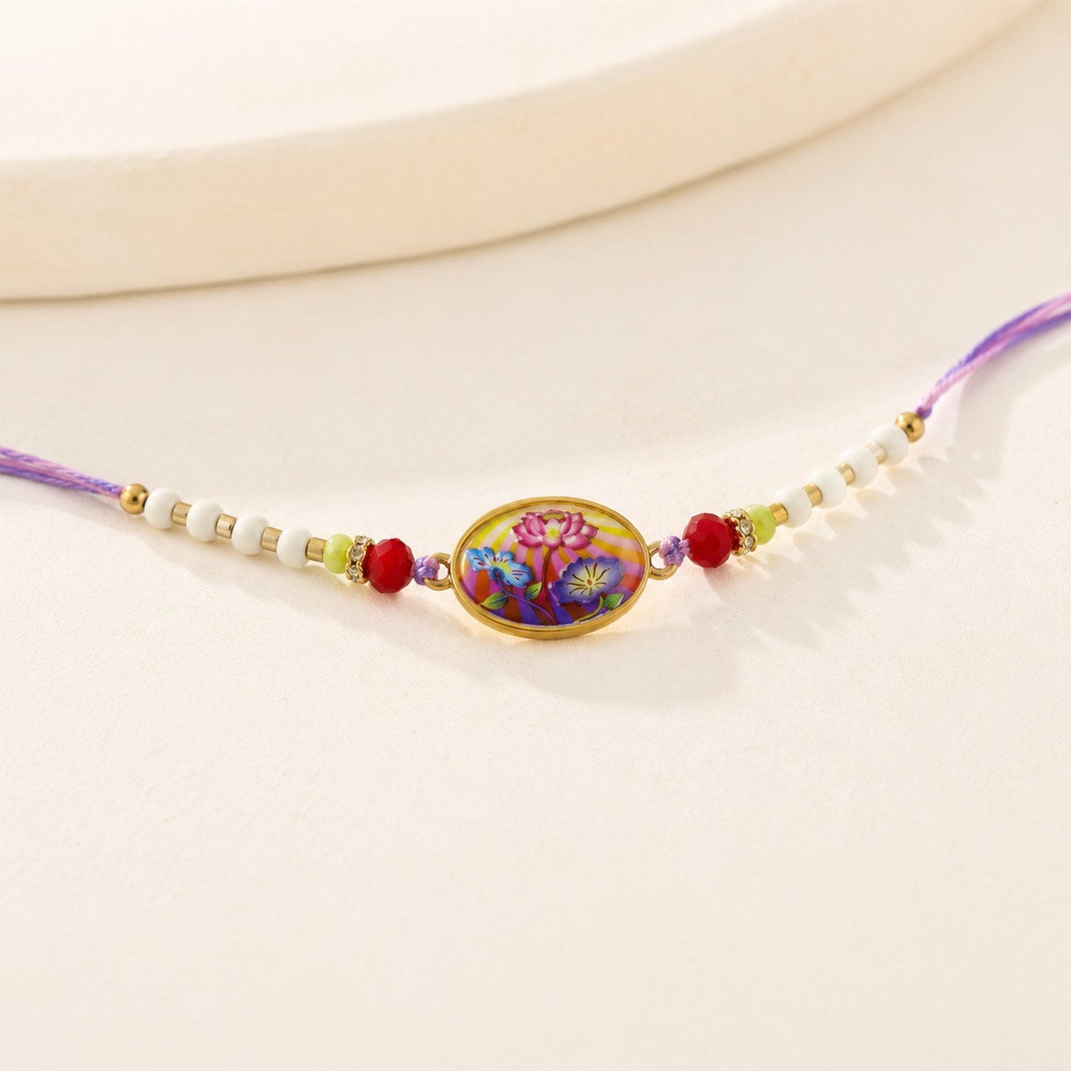 Side view of Floral Designer Rakhi showing thread and floral design