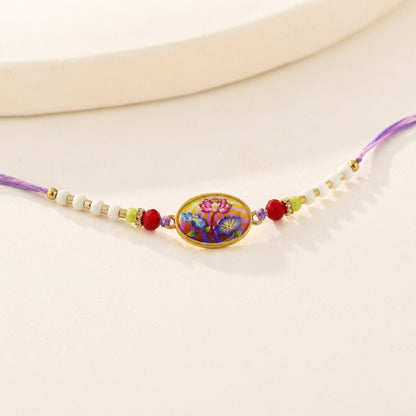 Side view of Floral Designer Rakhi showing thread and floral design