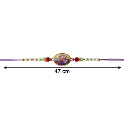 Decorative floral pattern on designer rakhi with purple thread