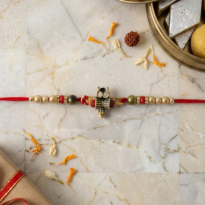 Side angle of Damru Trishul Designer Rakhi with beads
