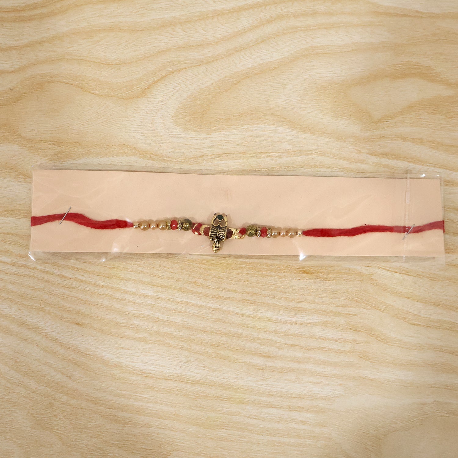 Full view of Damru Trishul Designer Rakhi with beads