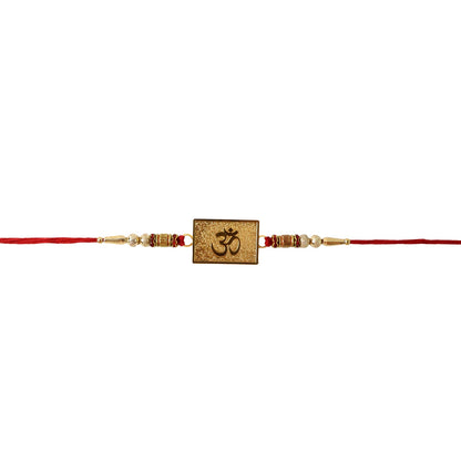 Om rakhi showing gold detailing and red thread