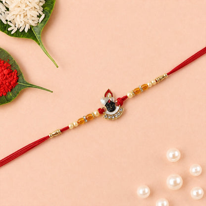Shrinathji Designer Rakhi tied in red thread showcasing design