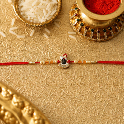 Side view of Shrinathji Designer Rakhi with pearl beads