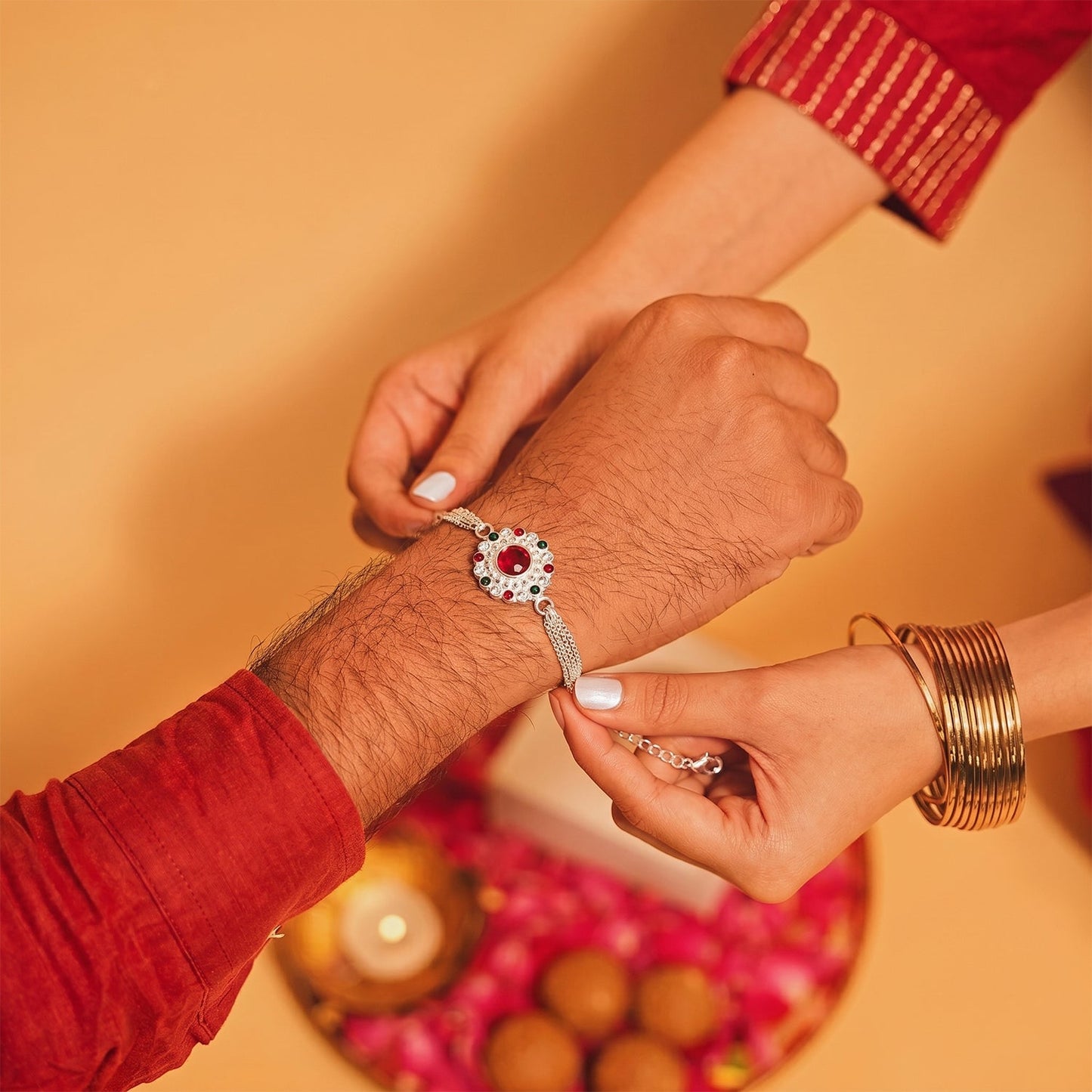 Silver Stone Chain Rakhi displaying red center stone