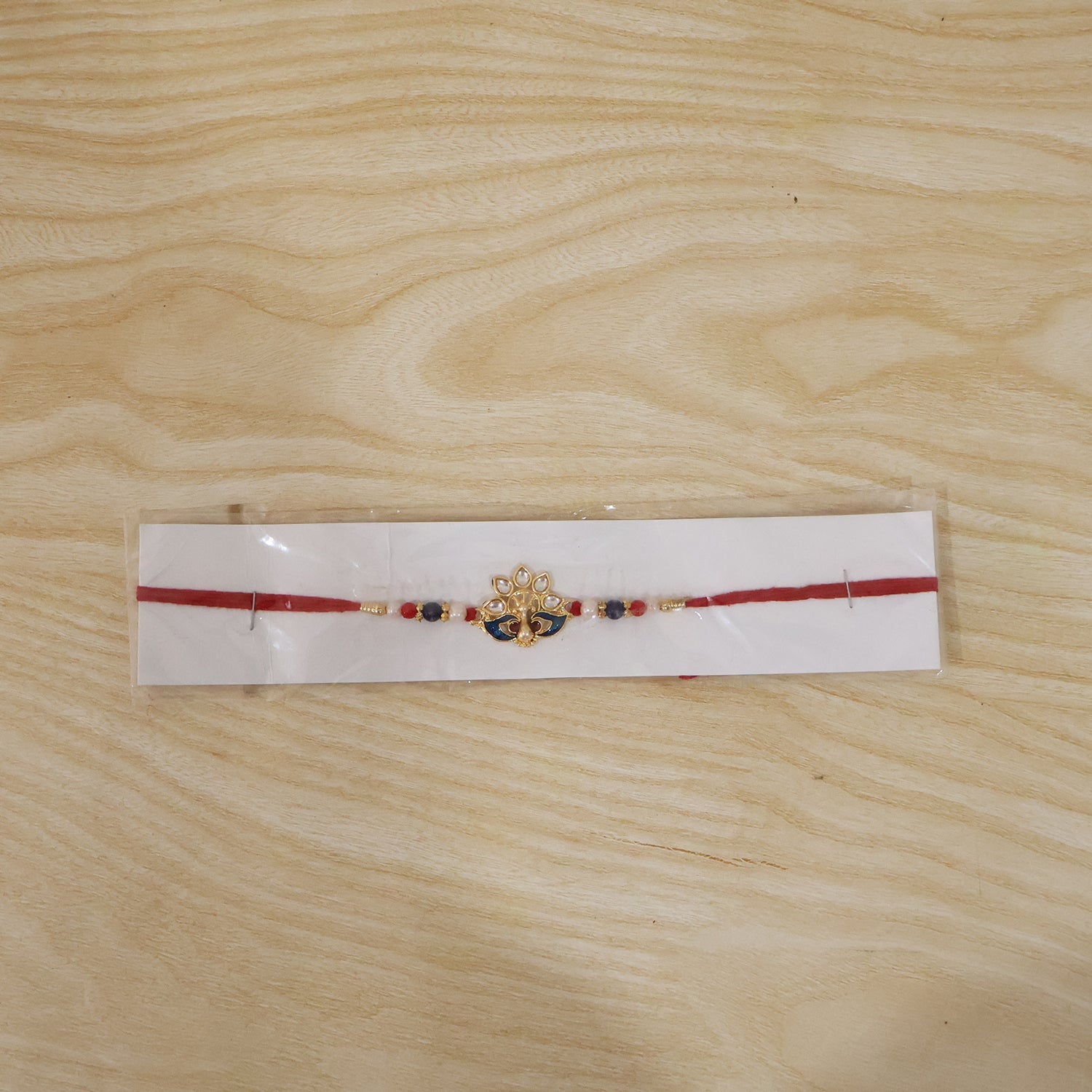 Peacock Designer Rakhi with Pearl Beads and Red Thread (1 Pc)