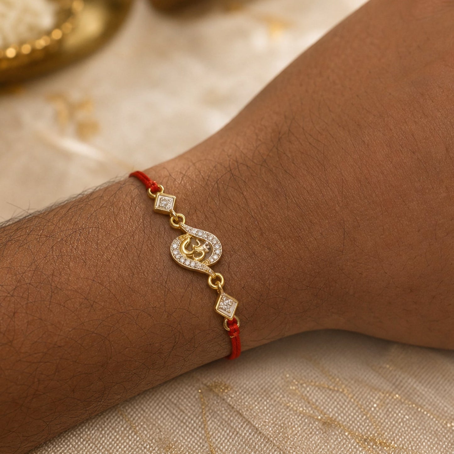 Golden Om Designer Rakhi with Stone Work and Red Thread (1 Pc)