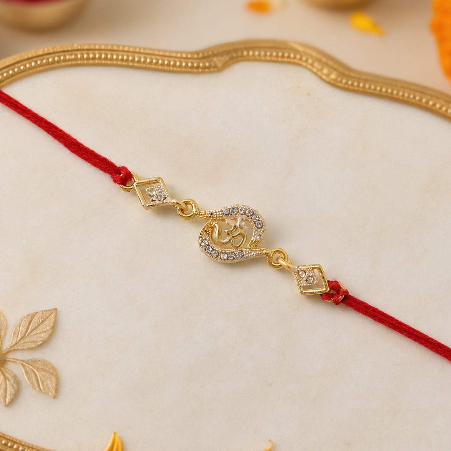 Golden Om Designer Rakhi with Stone Work and Red Thread (1 Pc)