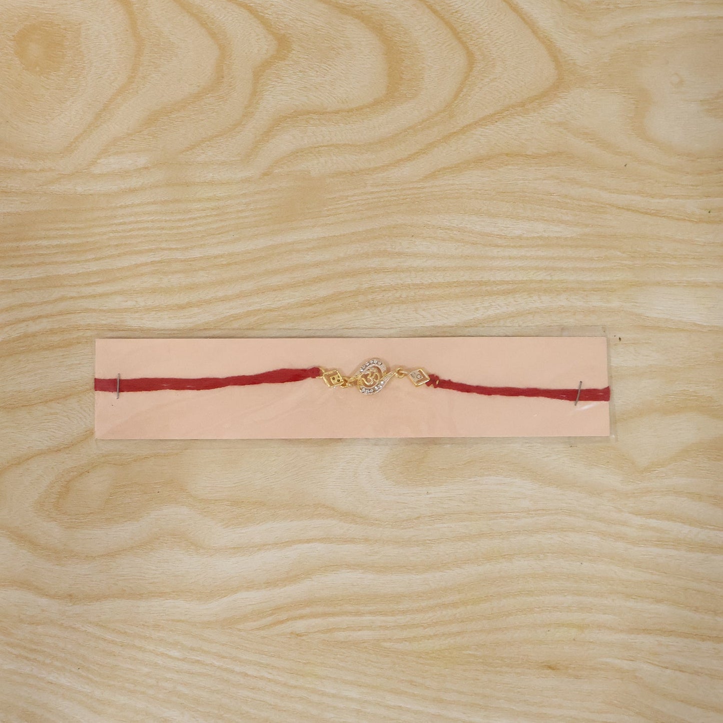Golden Om Designer Rakhi with Stone Work and Red Thread (1 Pc)