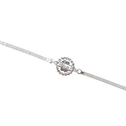 Silver rakhi worn on wrist, showing design