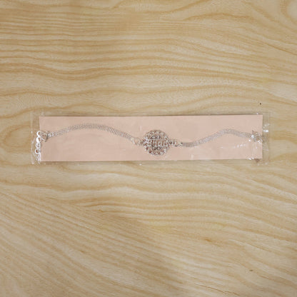 Silver rakhi displayed on a festive background