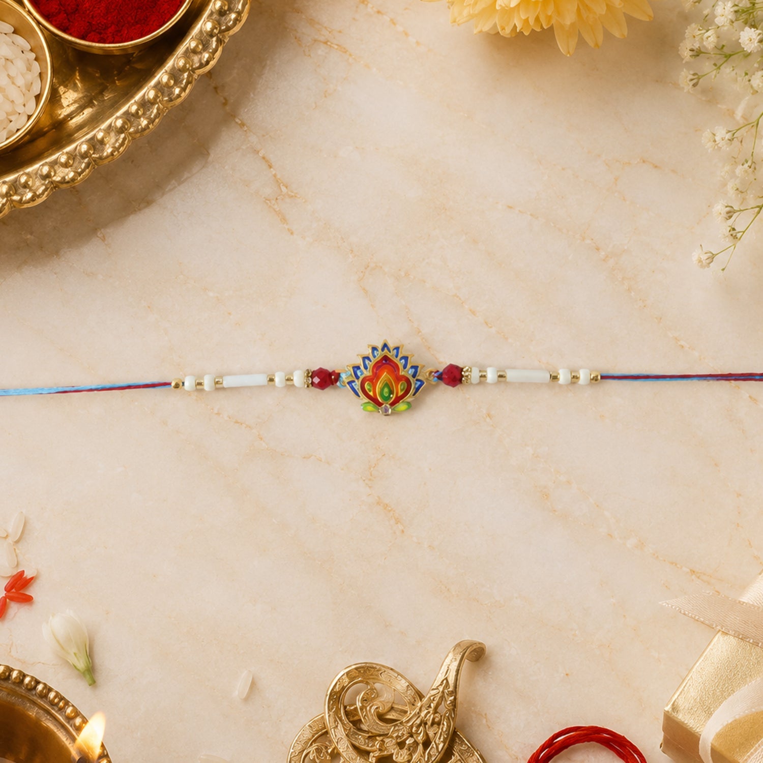 Close-up of peacock feather and bead details on designer rakhi