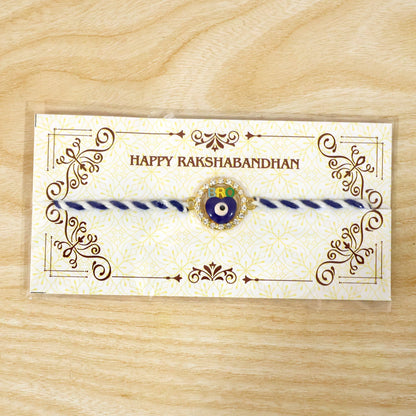 Blue evil eye fancy dori rakhi displayed flat on white surface