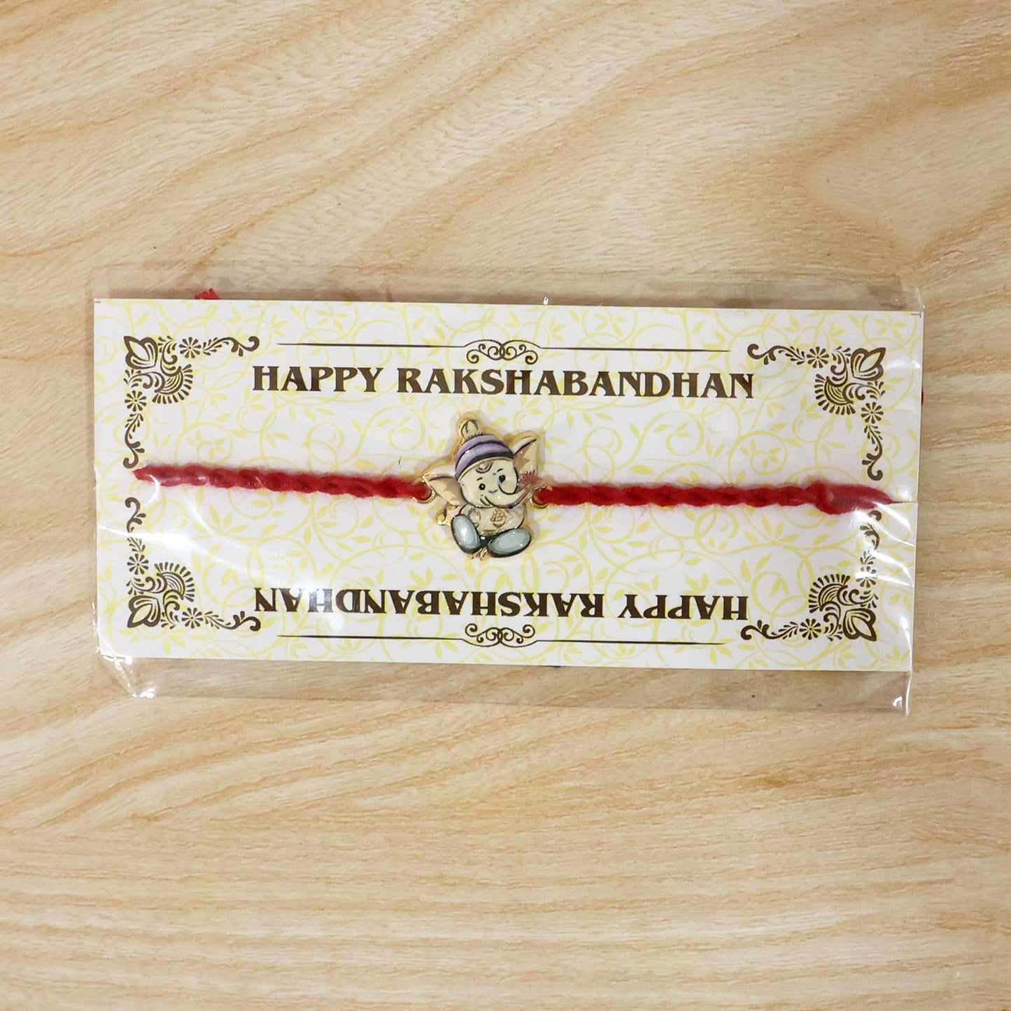Top view of Ganesh motif on fancy dori rakhi