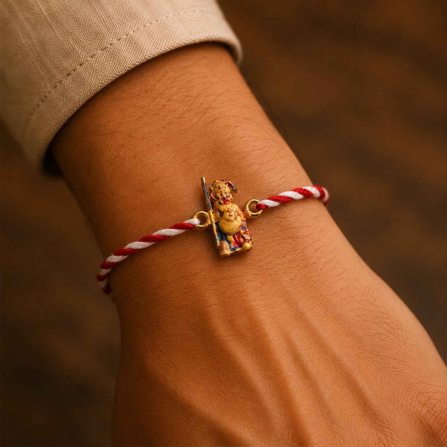 Close-up of Hanuman Ji rakhi showing detailed design and orange dori