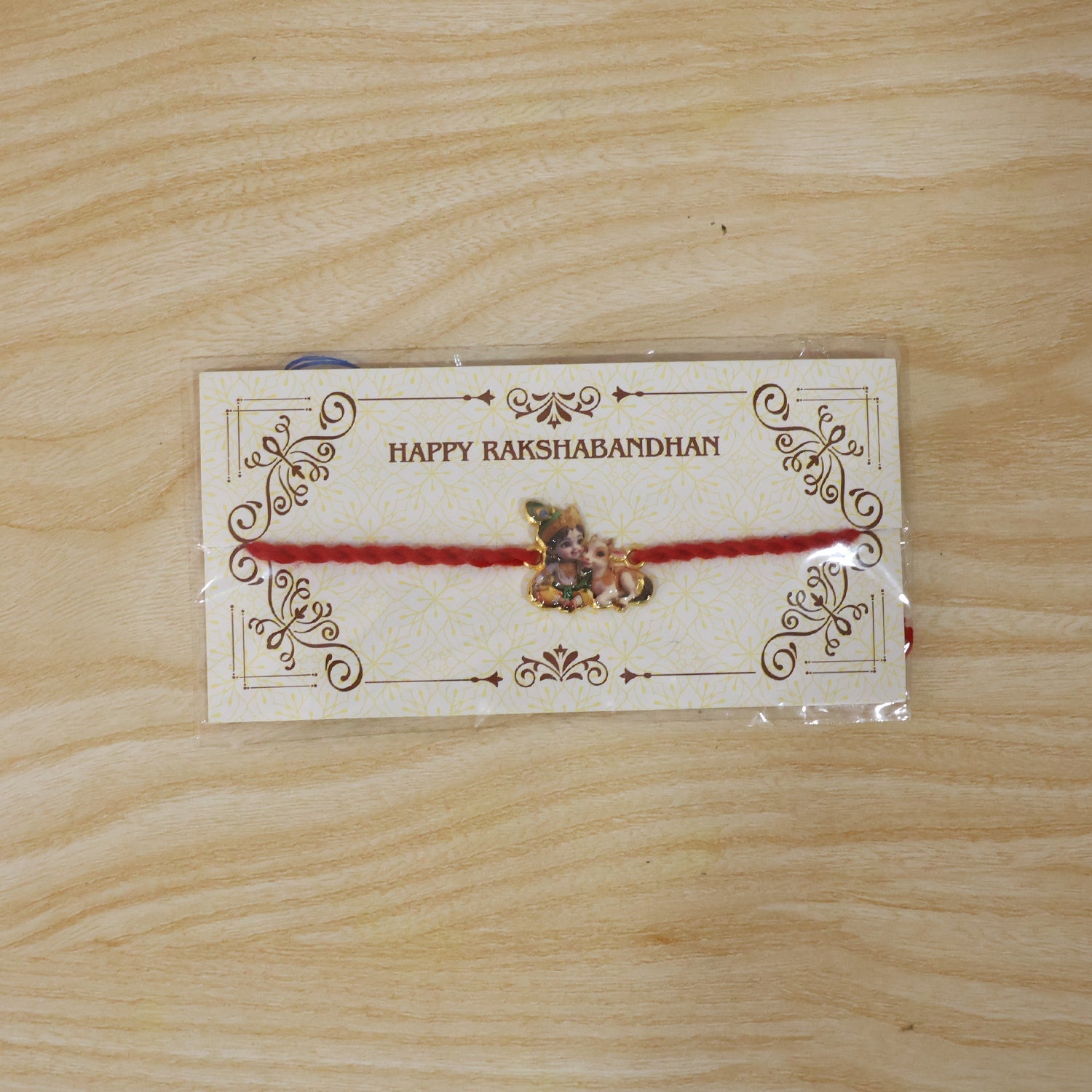 Bal Krishna with Cow Fancy Dori Rakhi packaging view