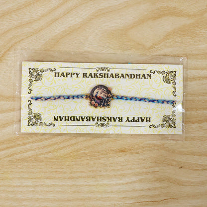 Close-up of charm and thread detail on Fancy Dori Rakhi for brother