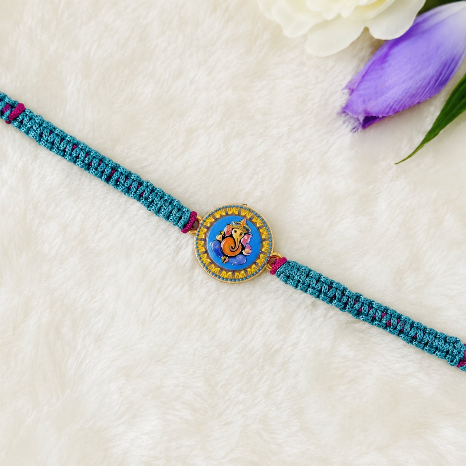Side angle of designer Ganesh rakhi with dori thread