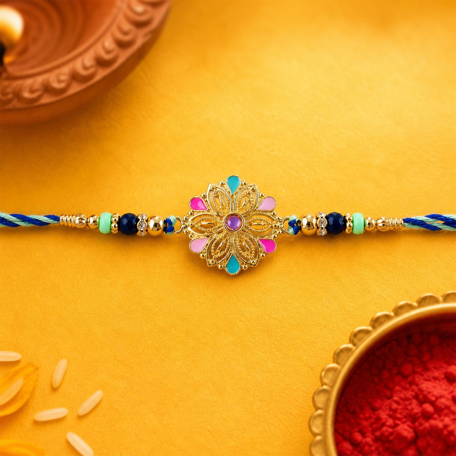 Designer rakhi showing floral charm and beads close-up