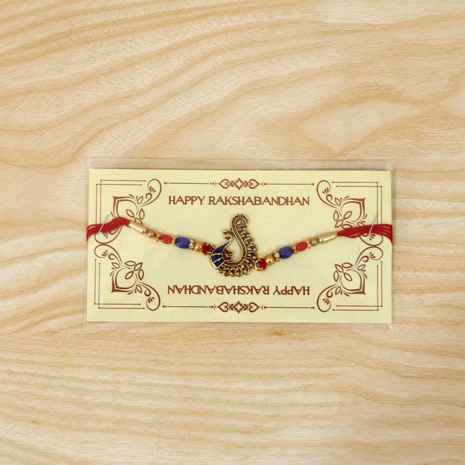 Side view of antique peacock rakhi showing bead details