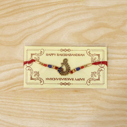 Side view of antique peacock rakhi showing bead details