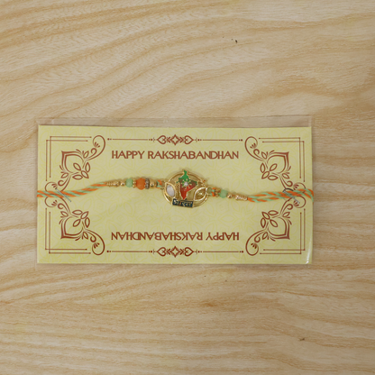 Close-up of India map charm on rakhi with beads