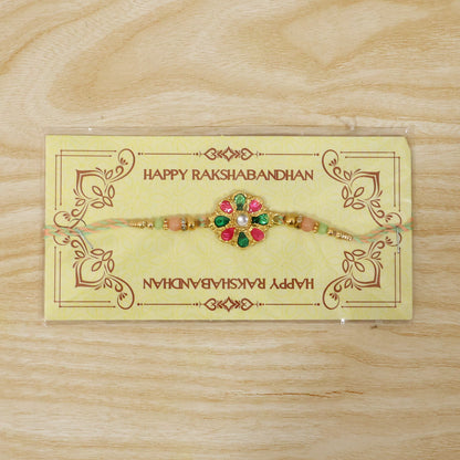 Bright and festive rakhi featuring colorful flower charm and beads