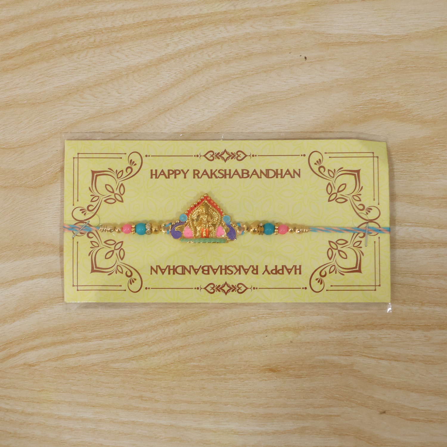 Designer Rakhi with idol charm and vibrant beads