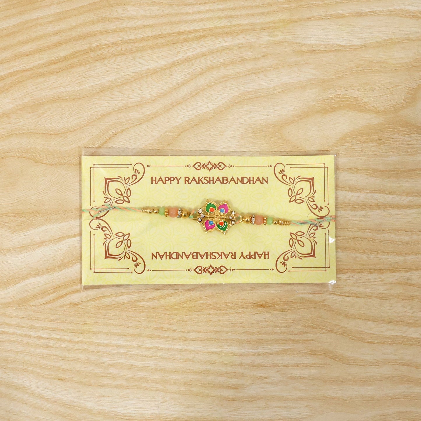Full view of stylish floral charm rakhi for brother