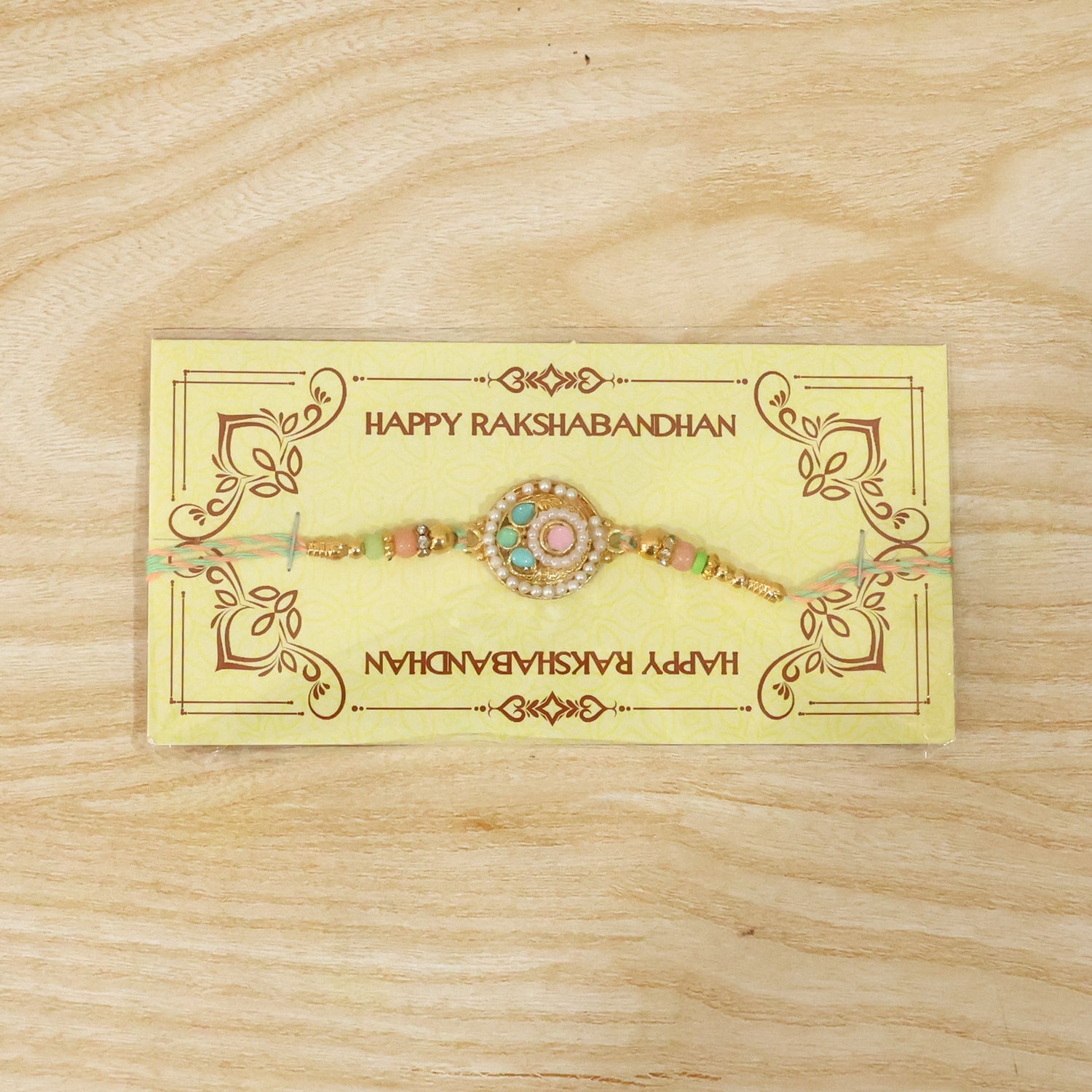 Pastel pearl rakhi with decorative beads on festive background