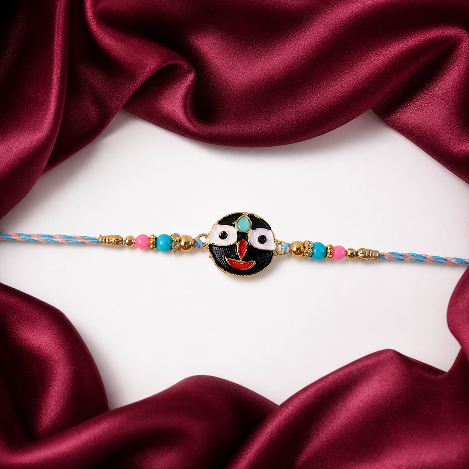 Designer rakhi with deity face charm and beads tied on thread