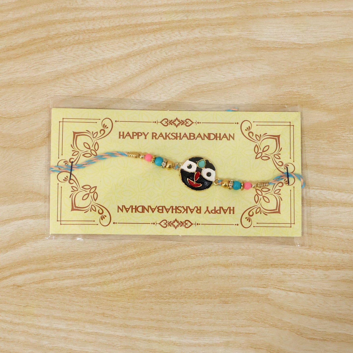 Festive rakhi featuring deity face charm with colorful beads