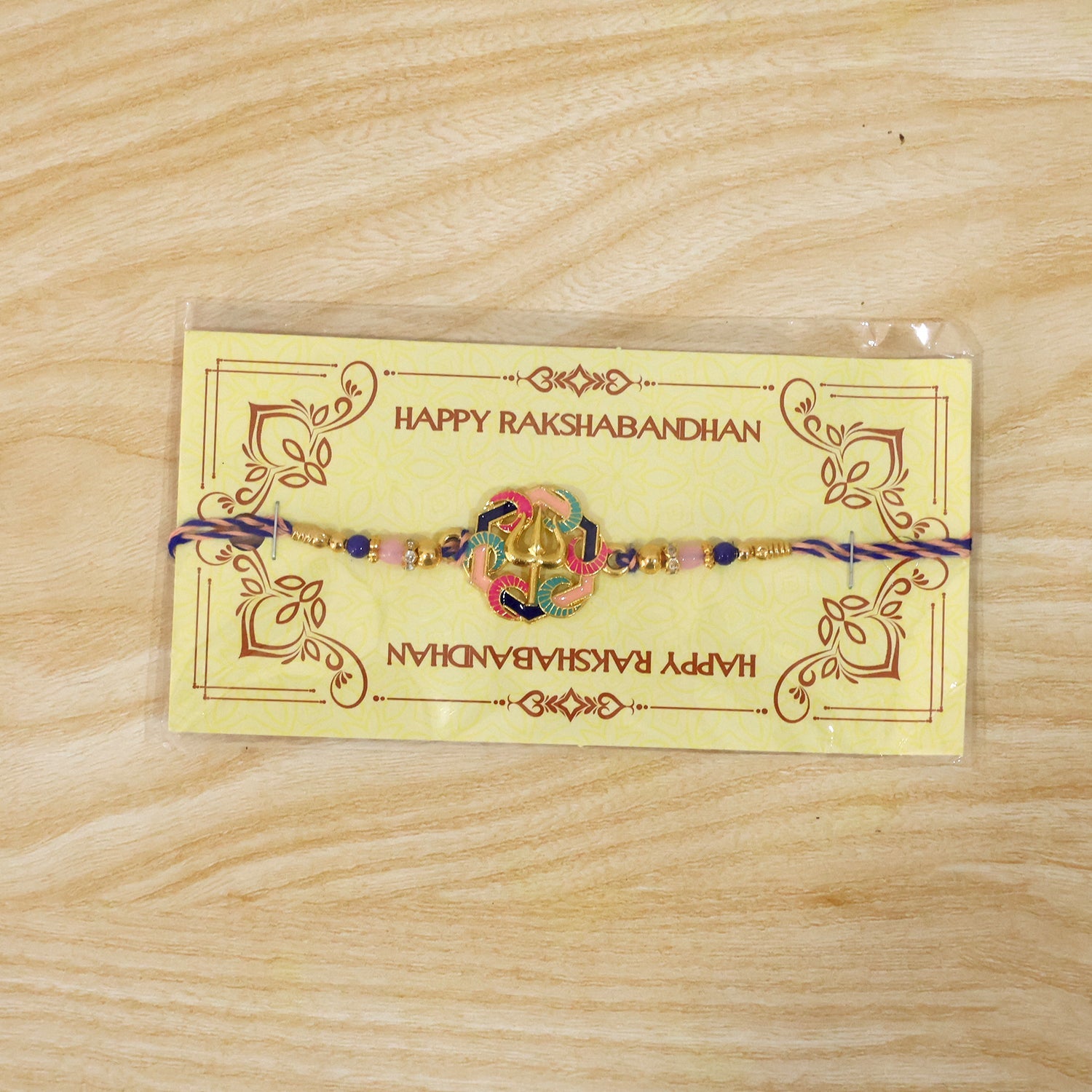 Beaded rakhi featuring vibrant trishul charm