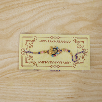 Side angle of blue enamel peacock charm rakhi with beads