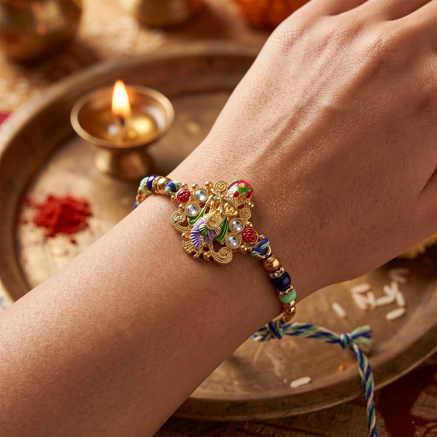 Close-up of divine idol charm on colorful rakhi with beads