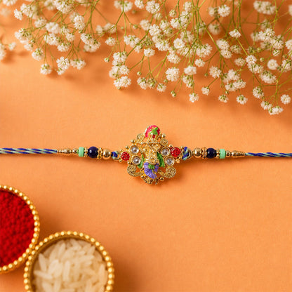Side view of colorful designer rakhi featuring divine idol charm
