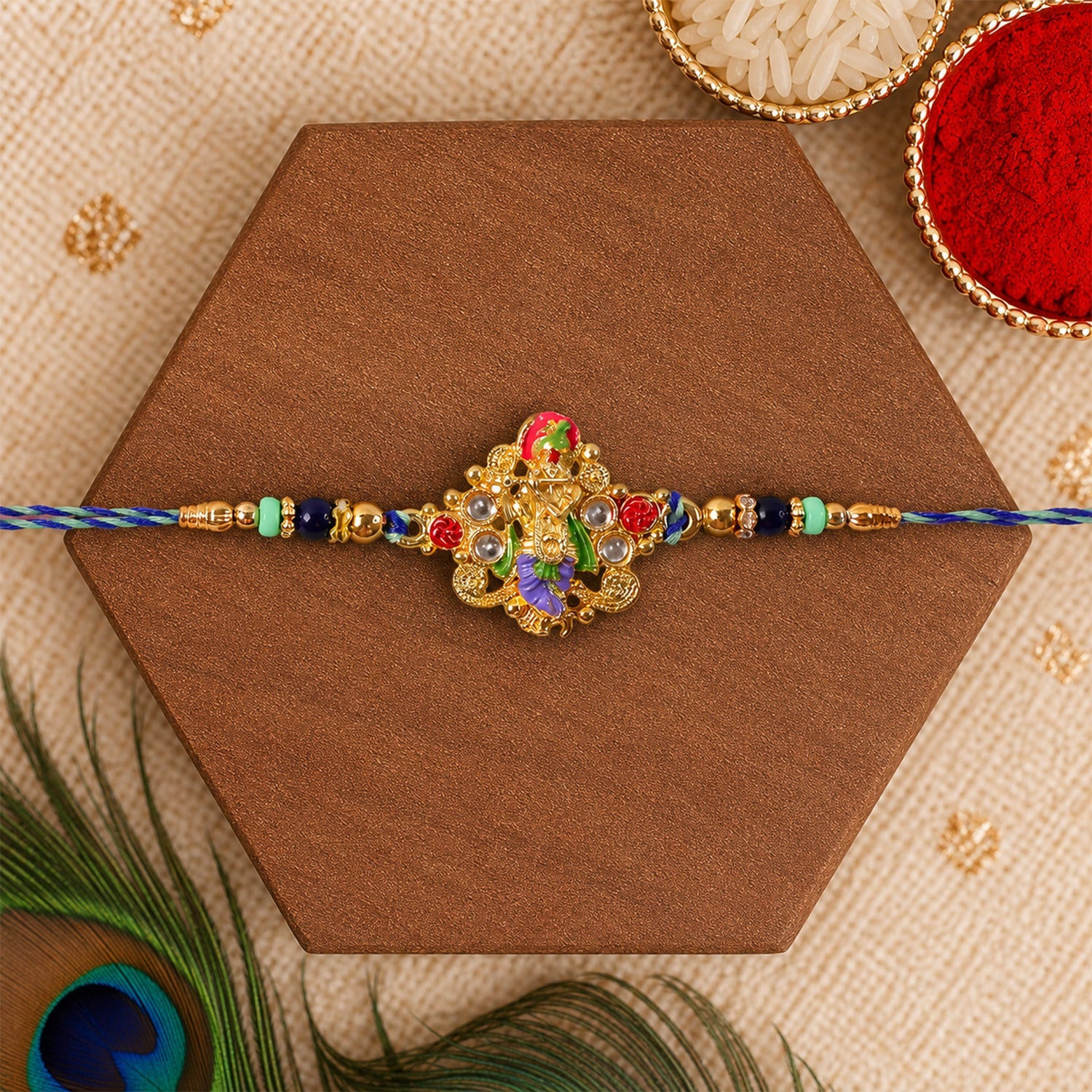 Festive rakhi with colorful beads and divine idol charm