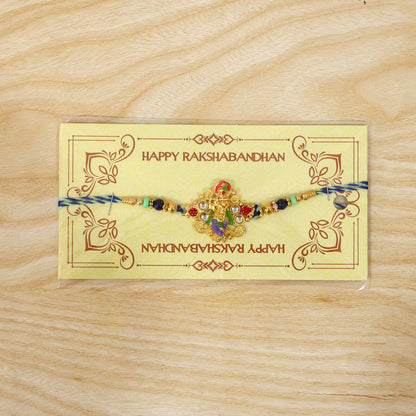 Detailed view of beads and divine idol charm on rakhi for brother