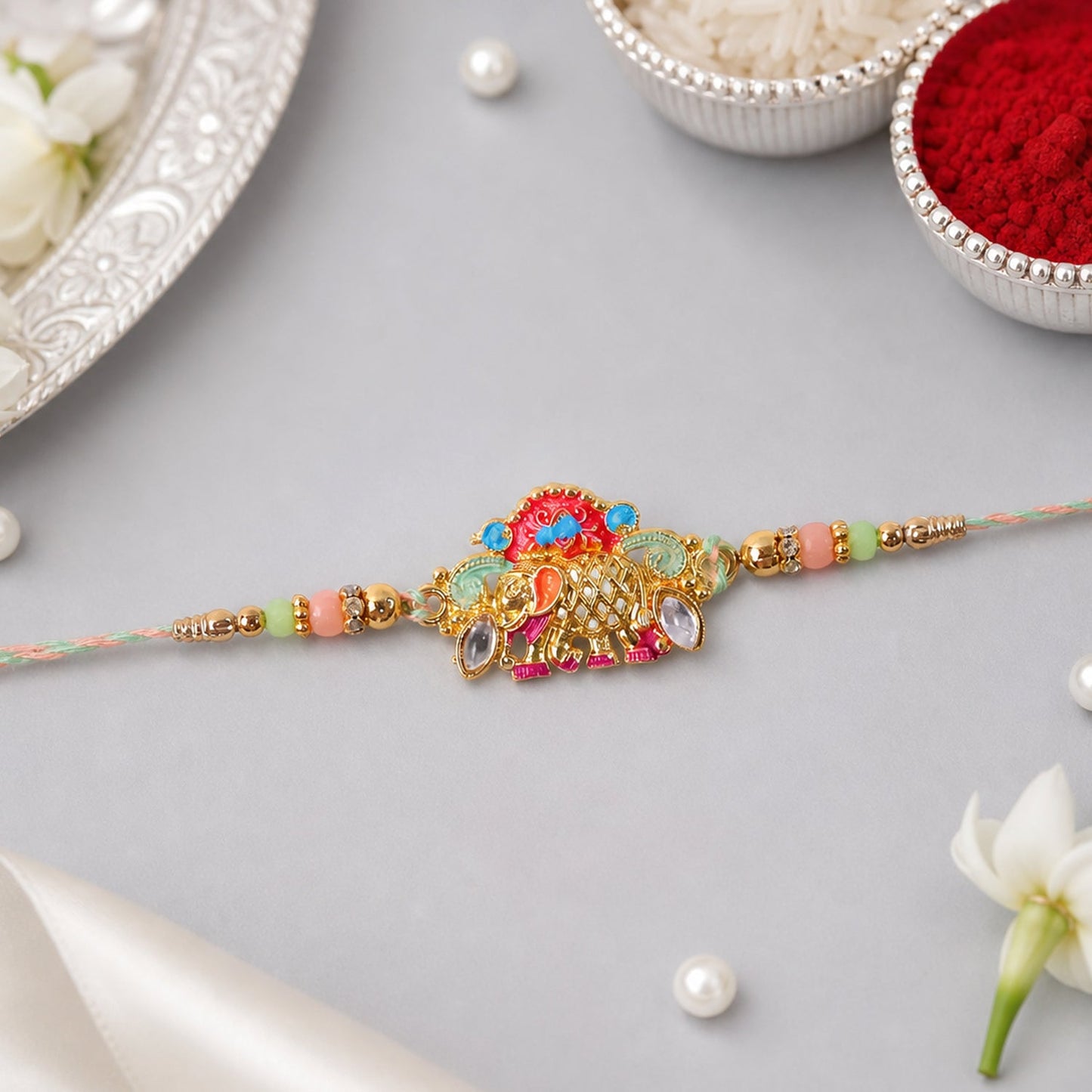 Designer rakhi showing colorful beads and elephant charm