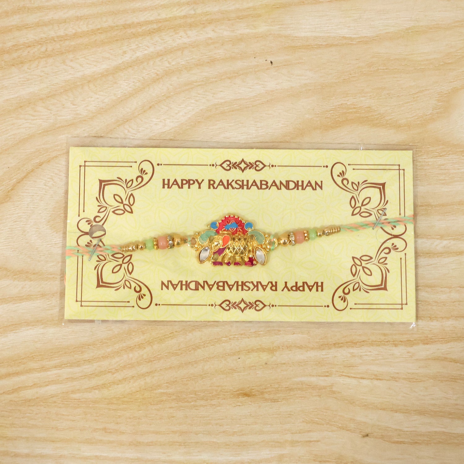 Stylish rakhi with elephant charm and multicolor beads