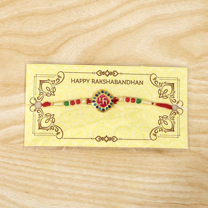 Traditional Raksha Bandhan rakhi showing swastik charm and beads