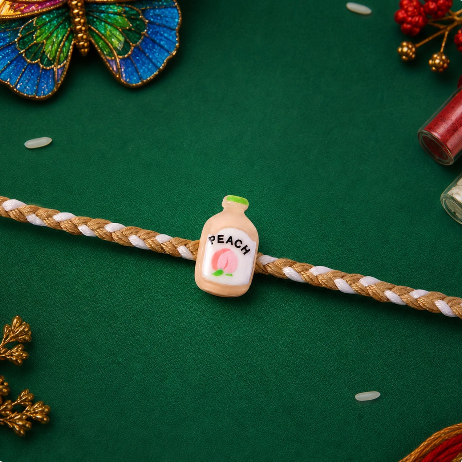 Close up of peach bottle charm on rakhi